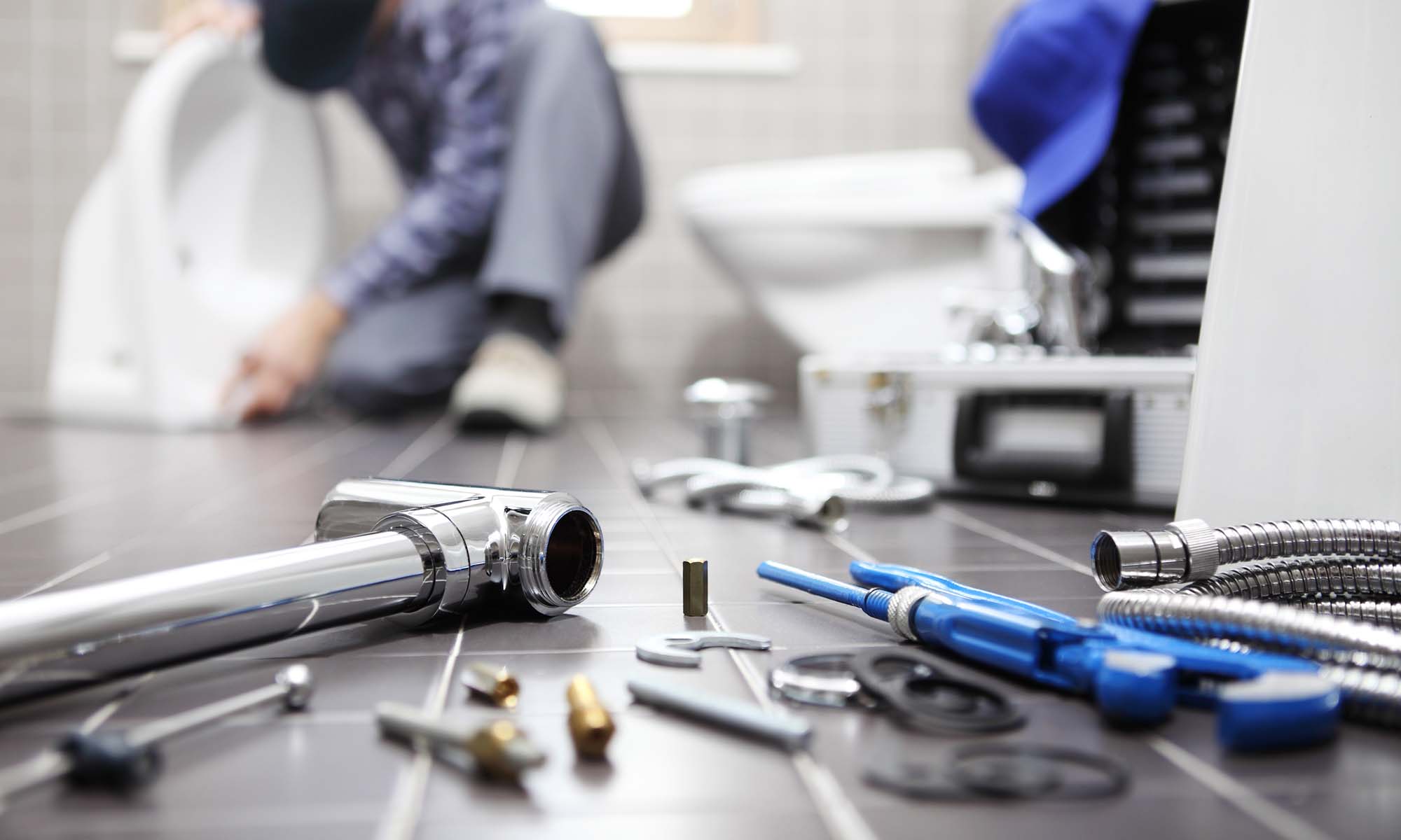 Plumber at work in a bathroom, plumbing repair service, assemble and install concept